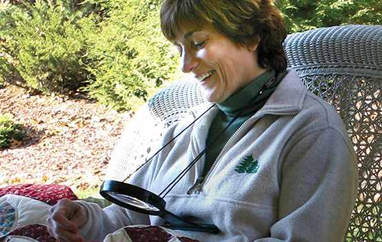 MagniFree™ a Hands Free, hanging 2x Magnifier with a 3.5x power bi-focal spot lens.